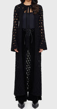Load image into Gallery viewer, Model wearing a black floor length cardigan on a white background