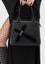 Load image into Gallery viewer, model in a black outfit with a hat, coat, and boots holding a matching handbag on a white background