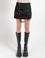 Load image into Gallery viewer, Black mini skirt with grommet details worn by a person on a white background