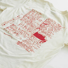 Load image into Gallery viewer, Back side of shirt showing red text