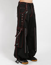 Load image into Gallery viewer, Black classic fit Tripp pants with red stitching, zipper details, removable straps on the back, drawstrings near the feet to tighten the fit, and red skulls printed on the back of each leg.