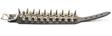 Load image into Gallery viewer, Black leather bracelet with three rows of silver spikes. Top and bottom row consist of 1/2" silver spikes. Center row consists of 1" silver spikes.