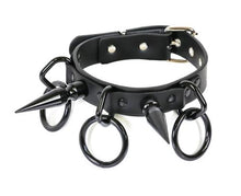 Load image into Gallery viewer, Black collar with large black D rings that have large black O rings hanging from them. Collar also has a black 3" spike on each side.