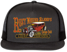 Load image into Gallery viewer, front of Black and orange/rust colored poplin-mesh snapback trucker cap. Hat has a rusty rat rod design called "Rust Never Sleeps" on the front and a "13" embroidered on the back left side. Backside has adjustable snap strap.
