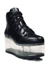 Load image into Gallery viewer, outer view of black vegan leather platform shoe with clear plastic platform. Shoe looks like a sneaker, but is super tall! Clear plastic bottom has a Velcro foot bed opening, to insert toys, candy or fun stuff into the clear bottom of the shoe.