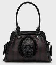 Load image into Gallery viewer, Black handbag with skull design on a light gray background
