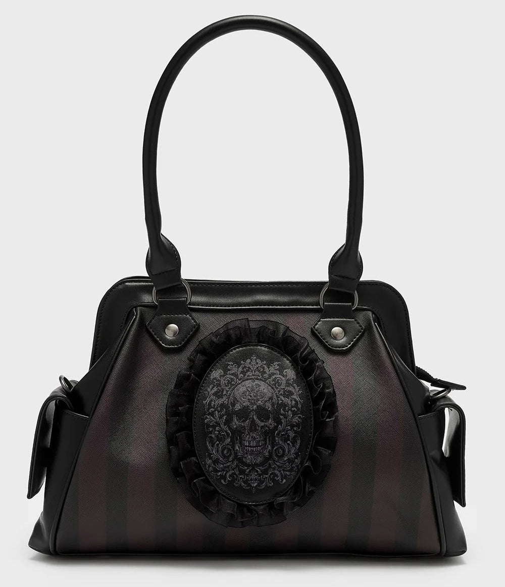 Black handbag with skull design on a light gray background