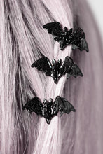 Load image into Gallery viewer, Black bat-shaped hair clips on a person&#39;s hair against a neutral background
