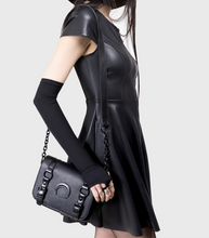 Load image into Gallery viewer, model in a black dress holding a black handbag against a white background
