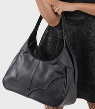 Load image into Gallery viewer, model wearing a black lace dress and black hat holding a black handbag on a white background
