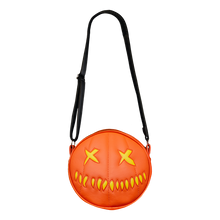 Load image into Gallery viewer, woman wearing bag on shoulder. bag is orange with yellow eyes and yellow teeth, with a black adjustable strap. based on sam&#39;s jack o lantern in the movie trick r&#39; treat
