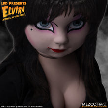 Load image into Gallery viewer, up close view of Elvira Living Dead Doll, with iconic black dress and batty, teased hair, and comes with a dagger that she can store in her waist belt. Stands 10” tall and features 5 points of articulation. Packaged in window box for display.
