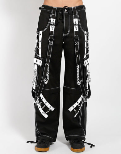 front of Black and white pants feature white stitching, removable straps, adjustable ankles, D-rings, clasps, and deep pockets.