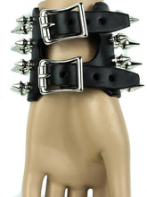 Load image into Gallery viewer, Black leather bracelet with four rows of 1&quot; spikes, four rows of 1/2&quot; spikes.
