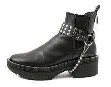 Load image into Gallery viewer, black ankle boot displaying black boot strap with three rows of multiple silver riveted studs and hanging silver chain underneath
