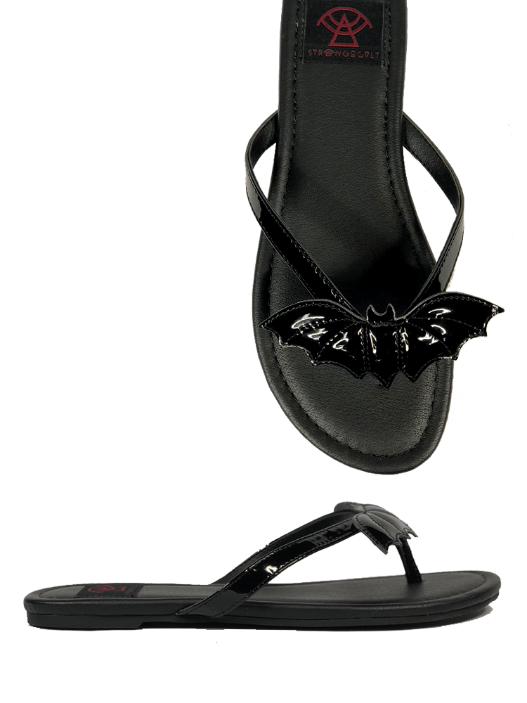 Black flat sandal with vegan leather patent bat on top.  Vegan leather with black rubber outsole.