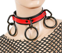 Load image into Gallery viewer, Black and red leather collar with three black D rings and hanging black O rings.
