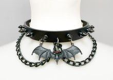 Load image into Gallery viewer, Black leather collar with 1/2&quot; black spikes, black hanging chain, and black bat with red eyes hanging from the front center.
