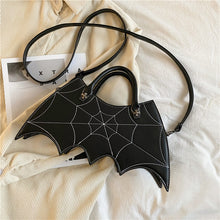 Load image into Gallery viewer, front side of purse showing White stitching spiderweb embroidery on front and hand straps and shoulder strap
