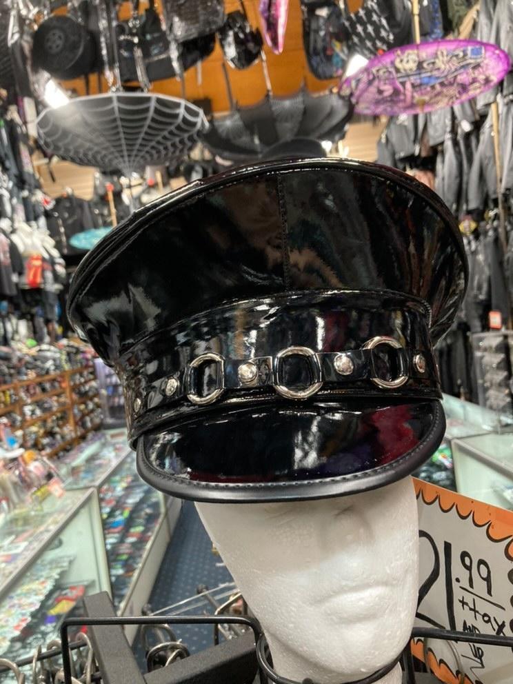 Black patent leather captains hat. Front of hat has three silver O ring details across the front.