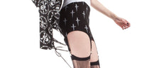 Load image into Gallery viewer, side of Black garter skirt with white all over print Lip Service classic dagger logo. Stockings not included.
