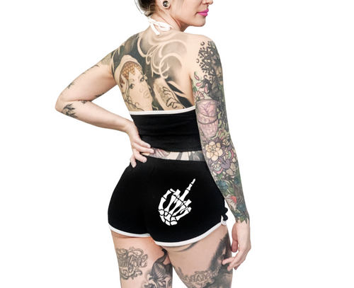 Women's black shorts with whitetrim and white skeleton hand middle finger design on right buttcheek, white drawstring and white cross bones on front left