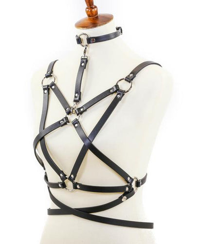 mannequin displaying black leather inverted pentagram shaped eight strap body harness with attached choker and multiple silver o rings
