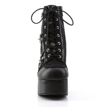 Load image into Gallery viewer, front side view of black vegan leather with suede panels 4.5 inch heel ankle boot with three O ring designs with spike in middle on each side of boot, tree spikes and s tuds on the back and 7 eyelet lace-up front 
