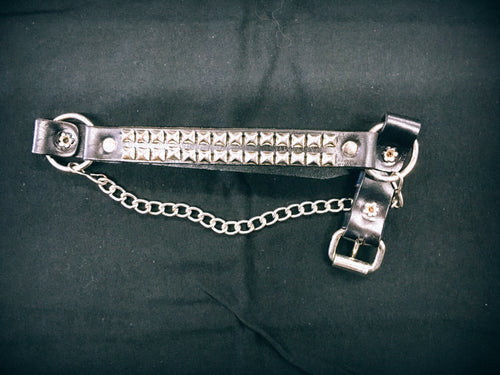 black leather boot strap with two rows of silver pyramid studs and silver hanging chain. shows adjustable buckle closure
