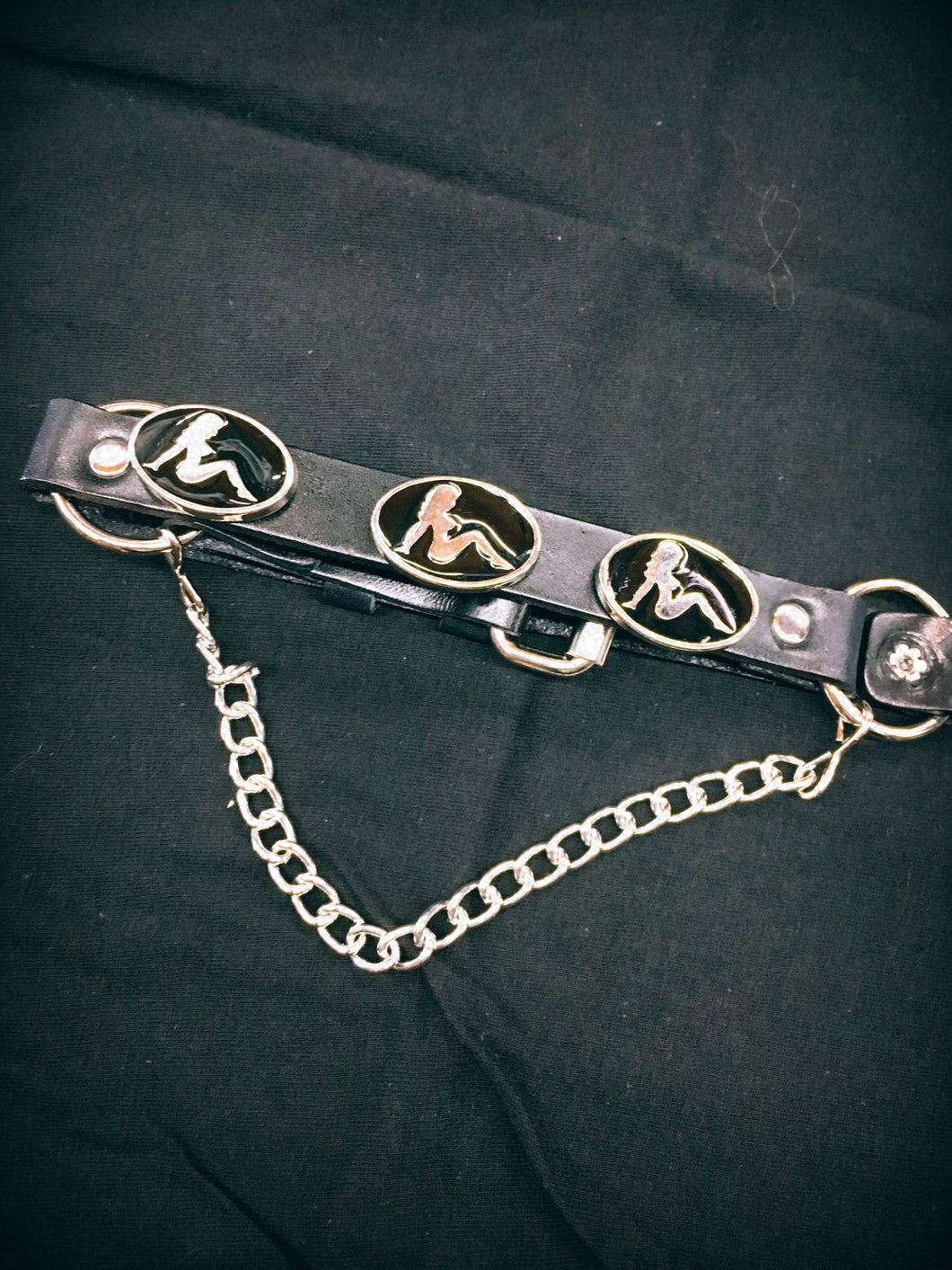 Three mudflap girl silver and black metal pins, with hanging chain and adjustable buckle closure