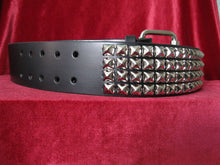Load image into Gallery viewer, wide width black leather belt with four rows of silver pyramid studs. shows silver adjustable buckle
