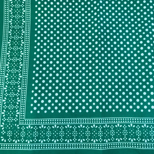 Green bandana with white polka dots pattern.