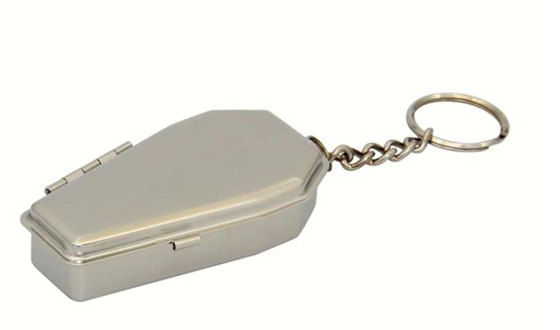 front side view of silver coffin shaped ashtray on hanging short chain keychain. Coffin opens and turns into an ashtray